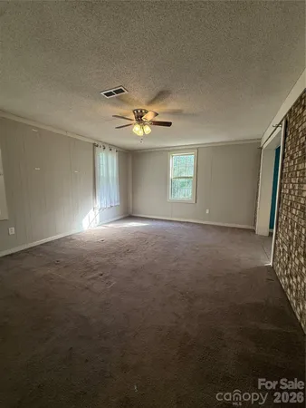 a view of a livingroom with a ceiling fan and window
