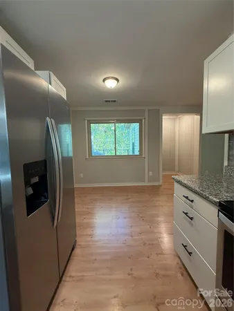 a view of cabinets with wooden floor and window