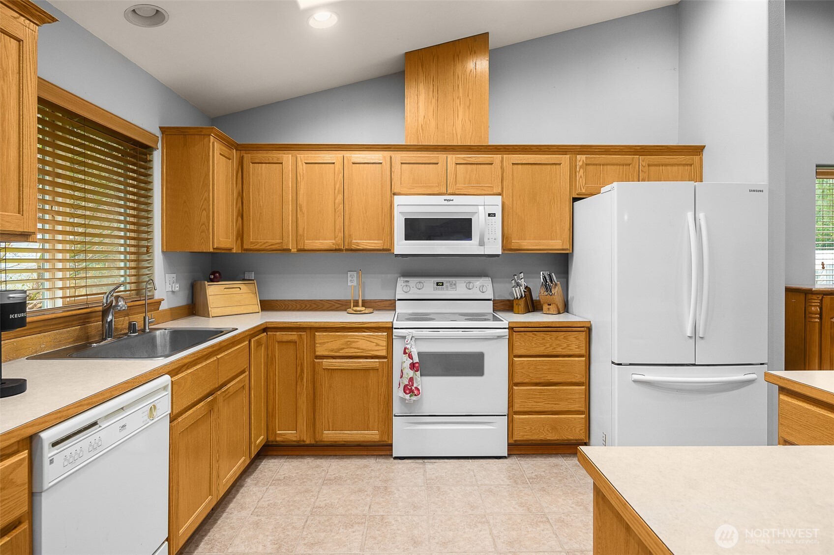 16617 Jim Creek Road Arlington, WA 98223 - Photo 12 of 40 a kitchen with a sink a refrigerator and cabinets