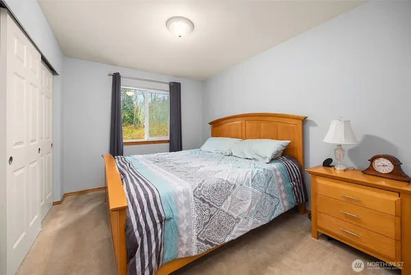 a bedroom with a bed and window