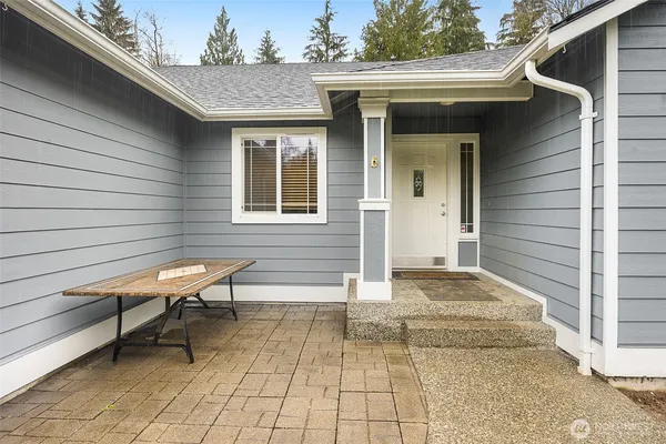 a view of a house with a lounge chair and a floor to ceiling window