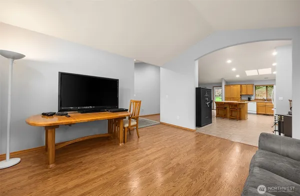 a living room with furniture pool table and a flat screen tv