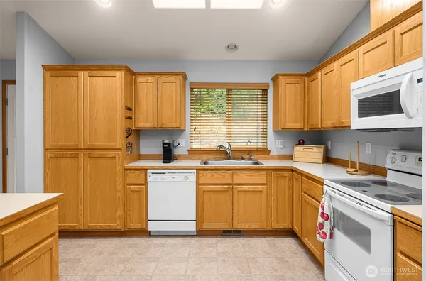 a kitchen with a sink cabinets and window