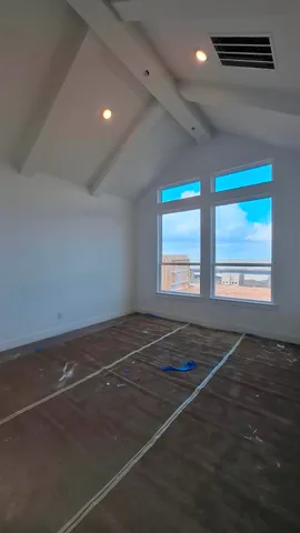 a view of a room with an empty space and window