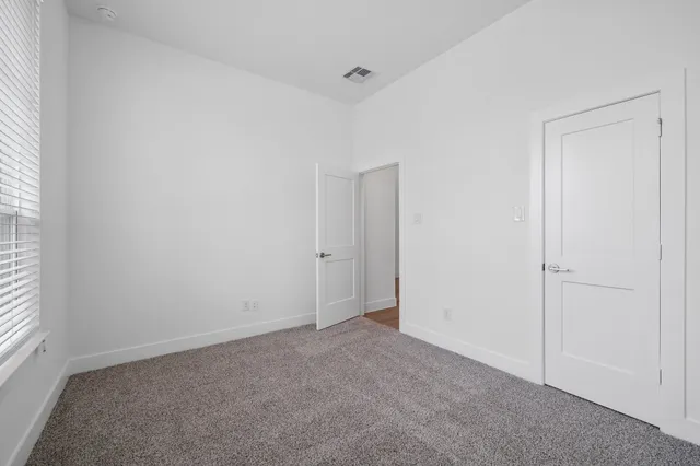 a view of an empty room and a window