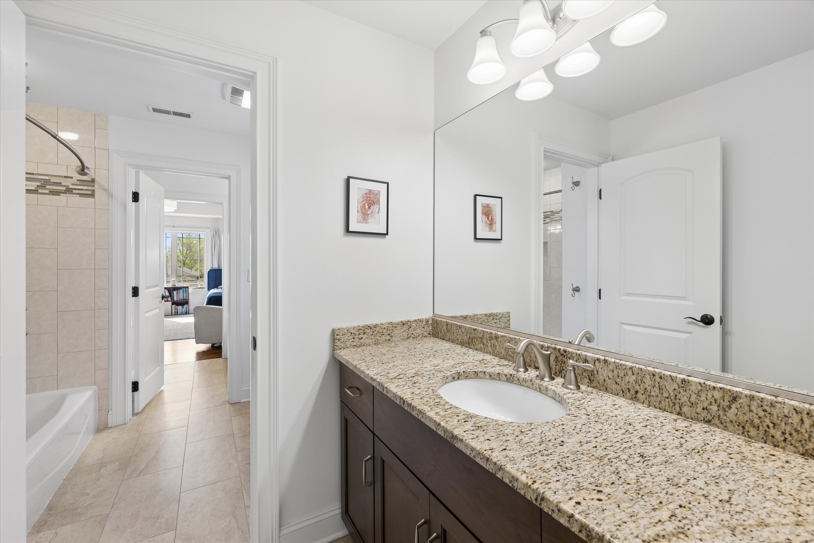 700 Swain Avenue Elmhurst, IL 60126 - Photo 18 of 33 a bathroom with a granite countertop sink a mirror and a shower