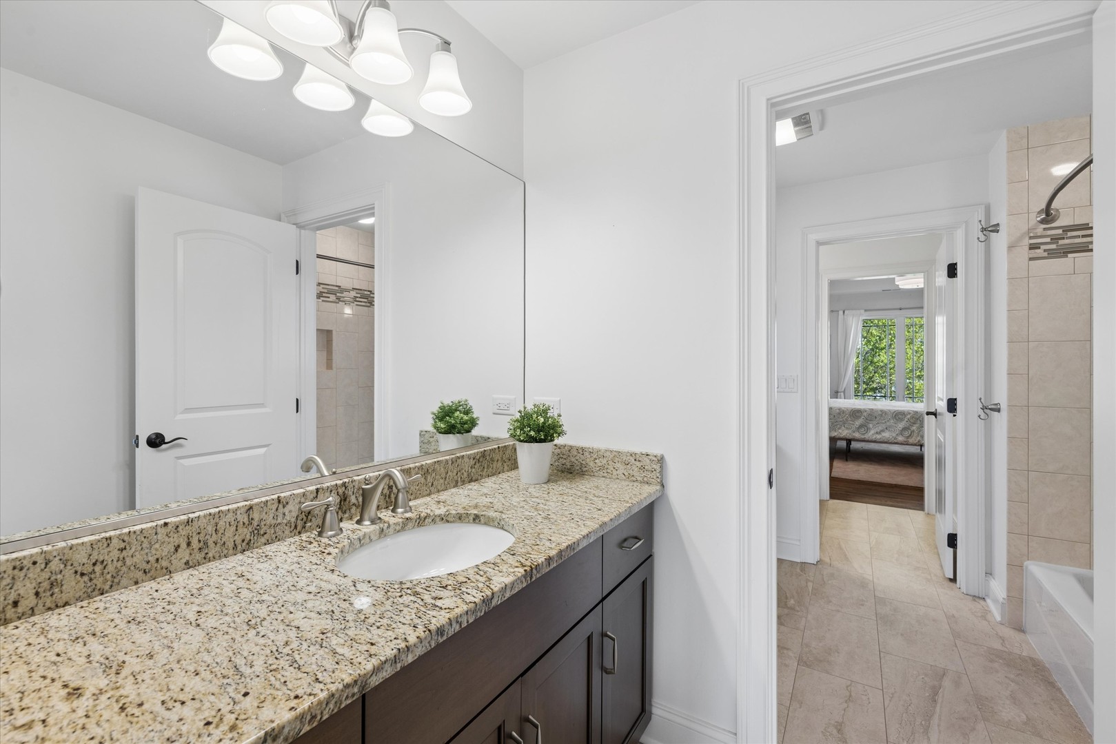 700 Swain Avenue Elmhurst, IL 60126 - Photo 19 of 33 a bathroom with a granite countertop sink and a mirror