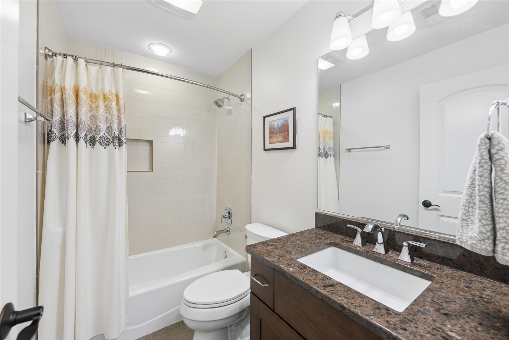 700 Swain Avenue Elmhurst, IL 60126 - Photo 24 of 33 a bathroom with a granite countertop sink a toilet a mirror a bathtub and shower