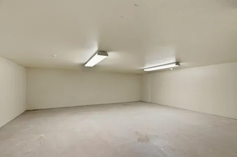 an empty room with a empty space and windows