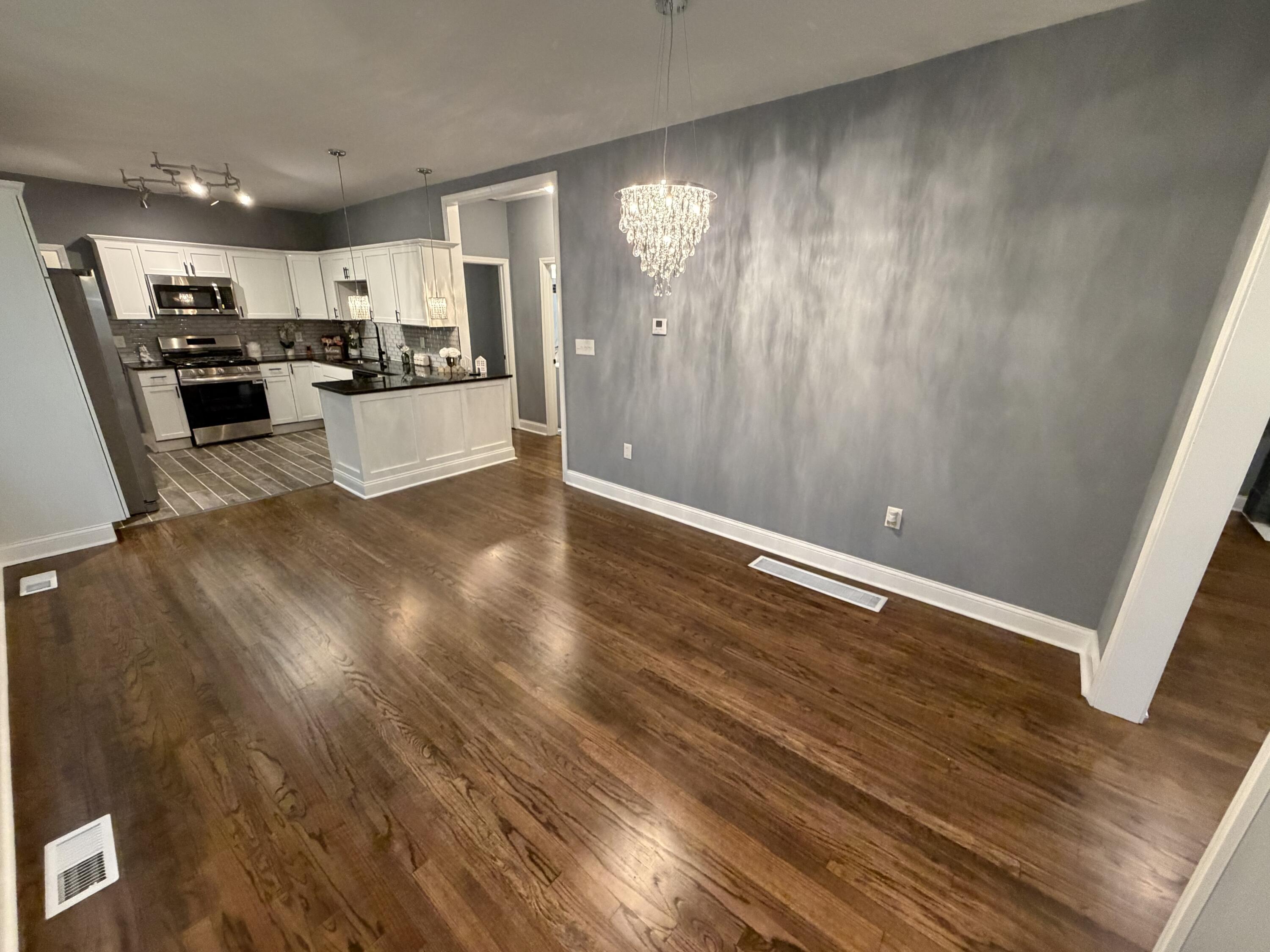4450 Washington Street Gary, IN 46408 - Photo 2 of 25 a view of kitchen with cabinets and wooden floor