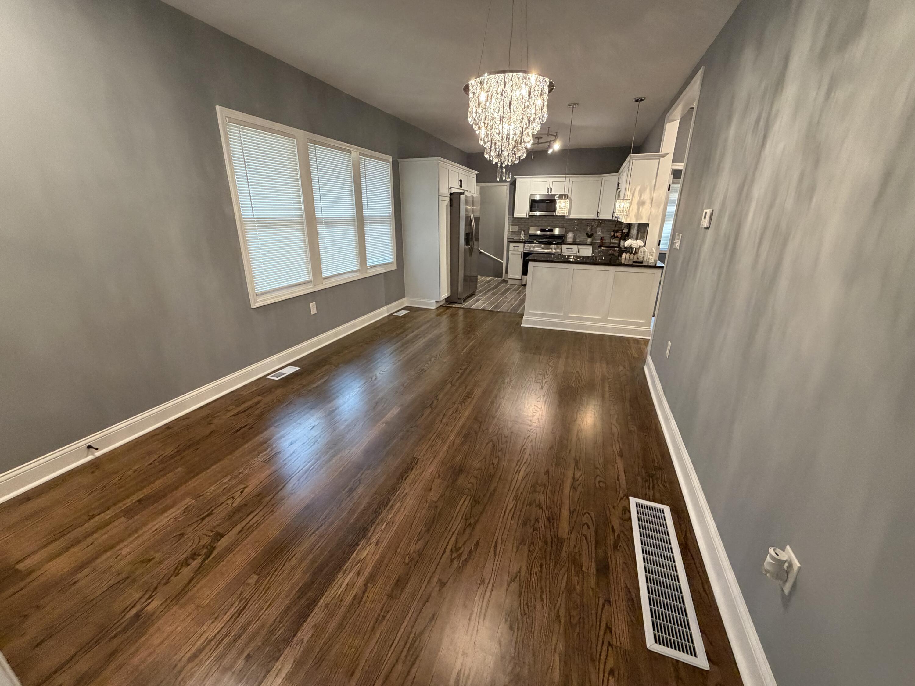 4450 Washington Street Gary, IN 46408 - Photo 7 of 25 wooden floor in an empty room with a window