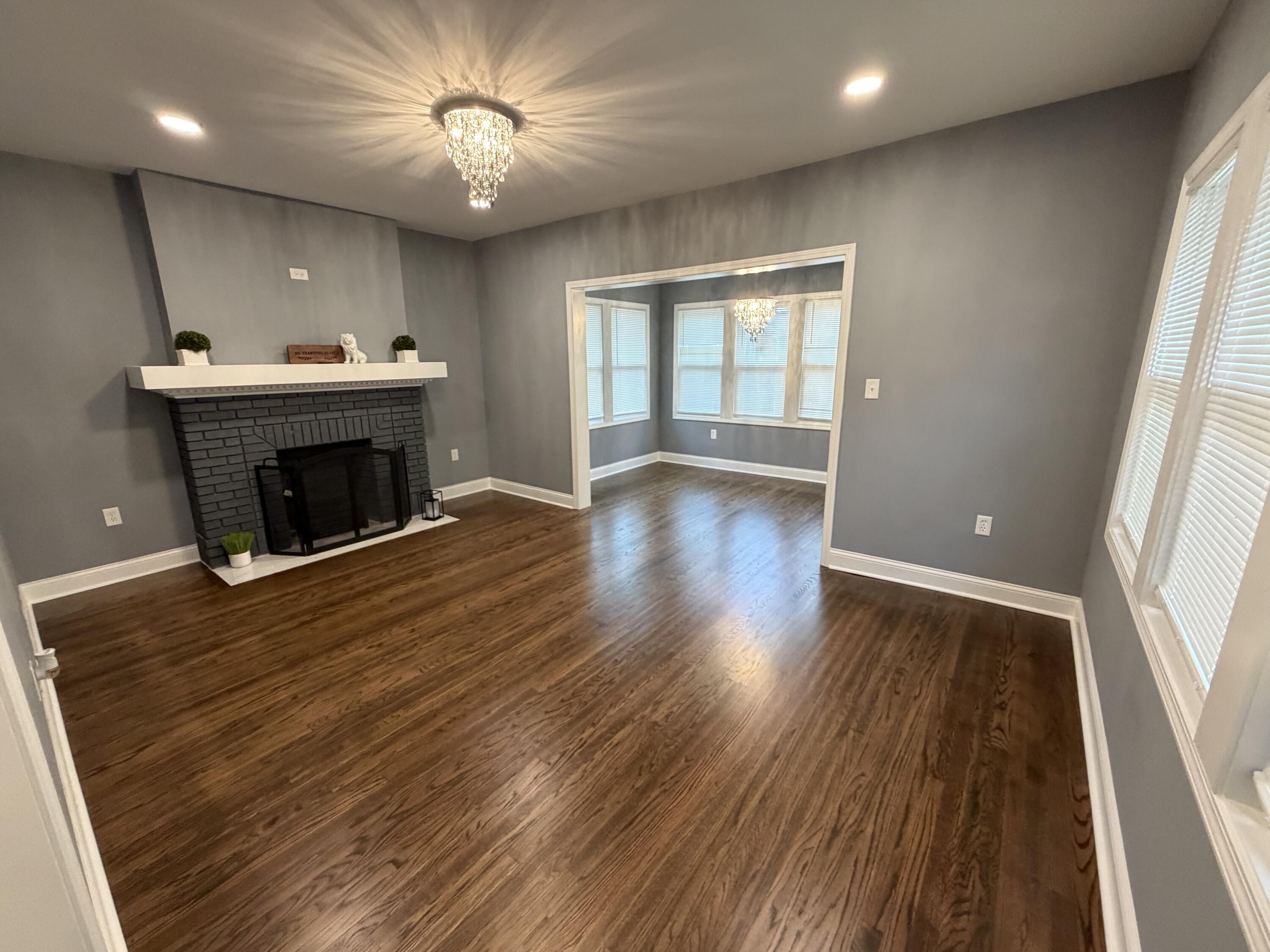 4450 Washington Street Gary, IN 46408 - Photo 8 of 25 a room with wooden floor and a fireplace