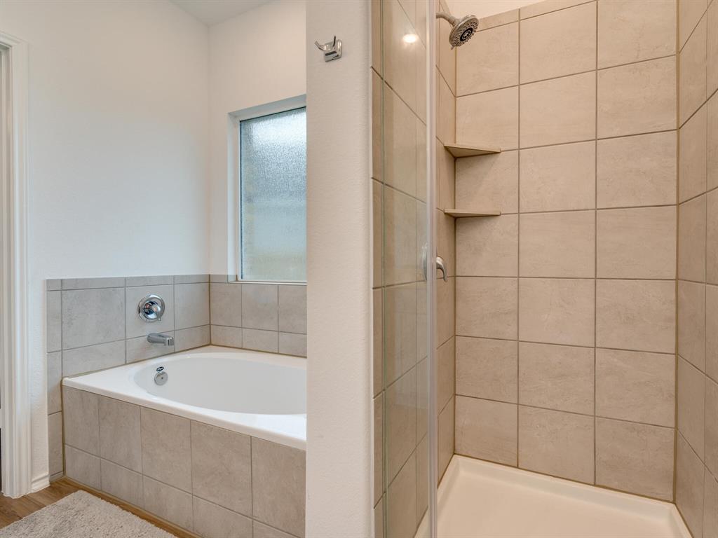 1208 Sweetspire Street Leander, TX 78641 - Photo 17 of 36 Bathroom featuring a built-in tub with tile surround and a separate shower enclosure