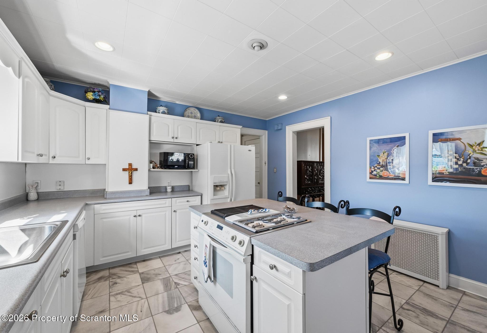 616 Myrtle Street Scranton, PA 18510 - Photo 16 of 65 a kitchen that has a cabinets and a stove in it
