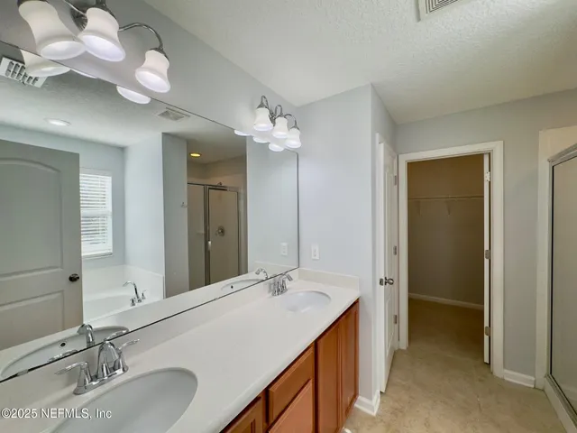 a bathroom with a sink vanity and a mirror