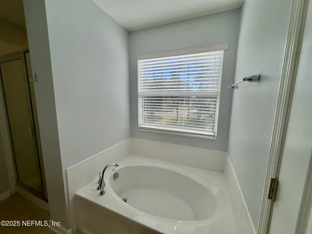 a white bath tub sitting next to a window