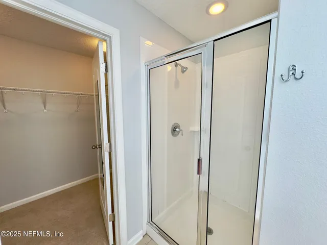 a bathroom with a glass shower door