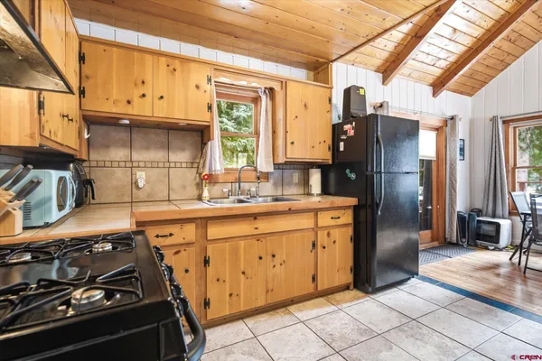 a kitchen with stainless steel appliances granite countertop a stove a refrigerator and a sink