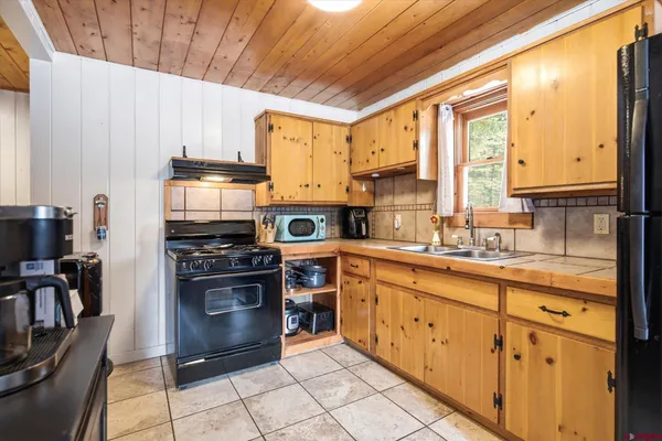 a kitchen with stainless steel appliances granite countertop a stove a sink dishwasher and a refrigerator