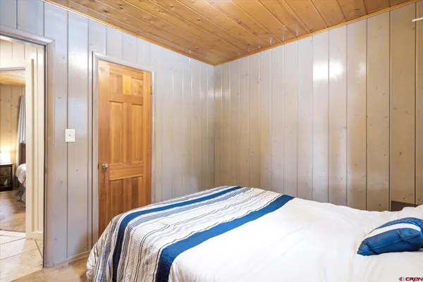 a bedroom with a bed and a mirror