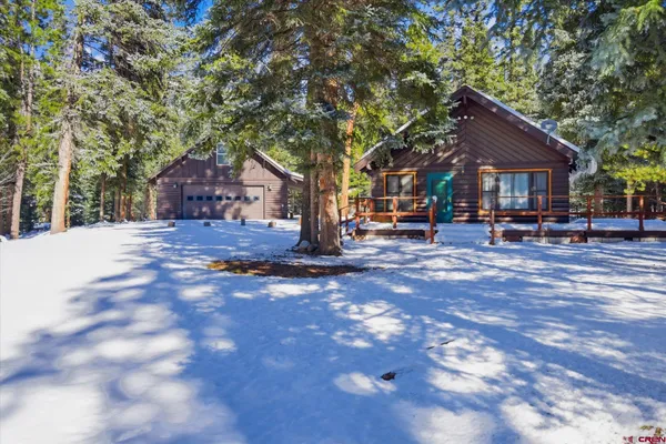 a wooden bench sitting in front of a house