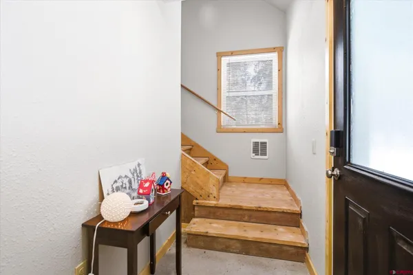 a bedroom with a large bed and a lamp with window