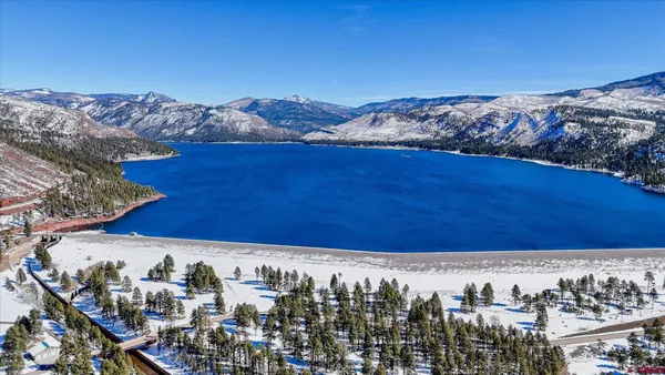 a view of a house with a yard covered in snow