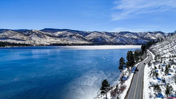 a view of a house with backyard and deck