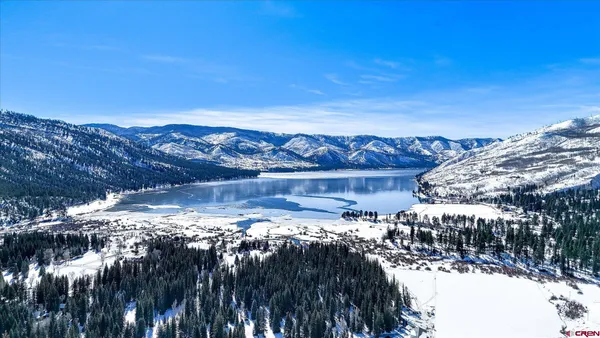 a view of a town with snow on the road