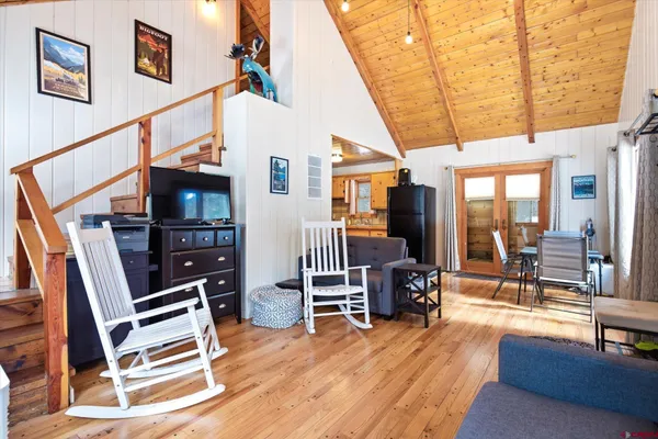 a living room with furniture and a wooden floor