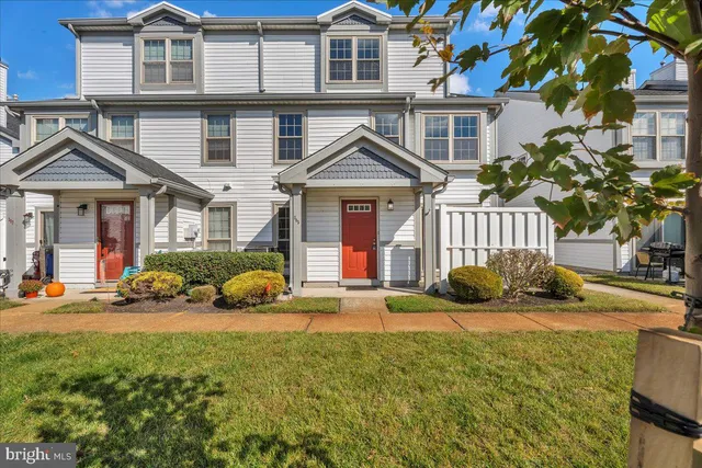 a front view of a house with a yard and balcony
