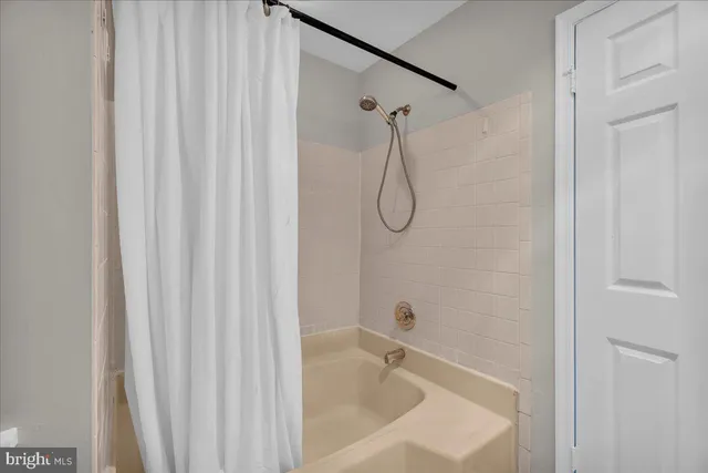 a bathroom with a shower and a shower