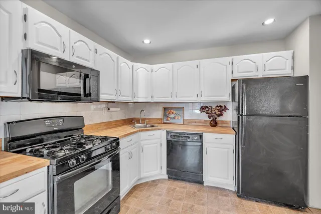 a kitchen with stainless steel appliances a refrigerator stove and sink