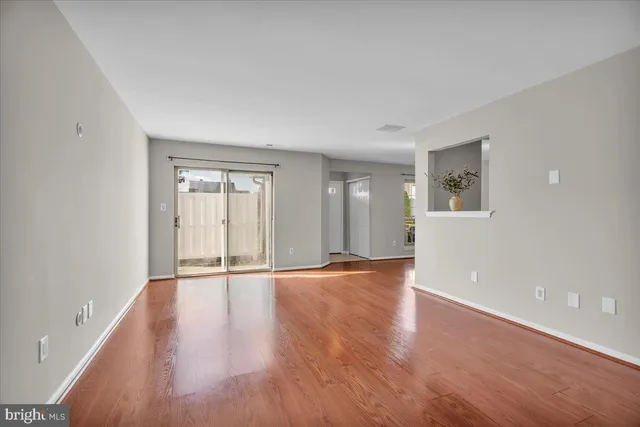wooden floor in an empty room with a window