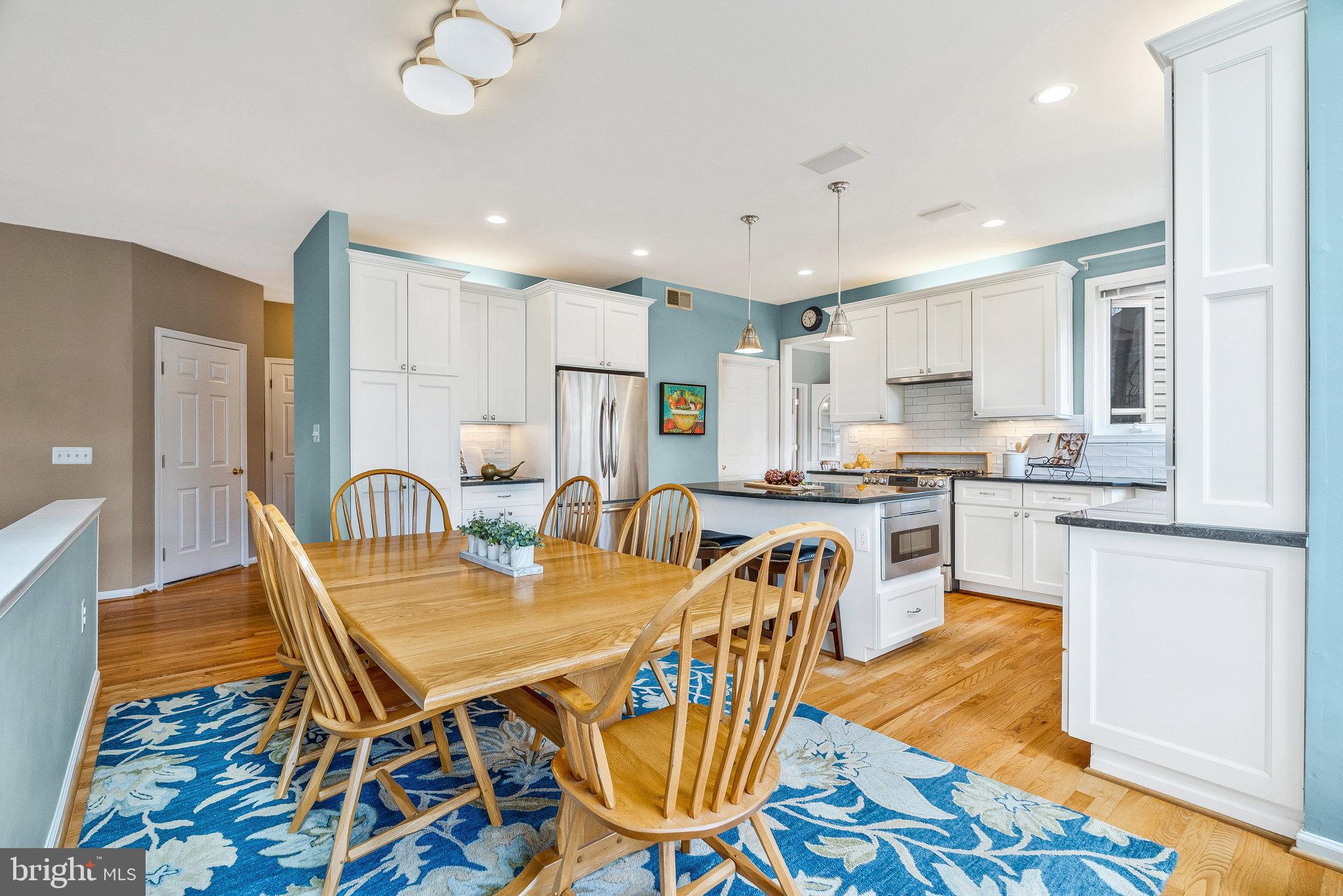 46865 Backwater Drive Sterling, VA 20164 - Photo 12 of 53 a dining room with stainless steel appliances granite countertop a dining table chairs and granite counter tops
