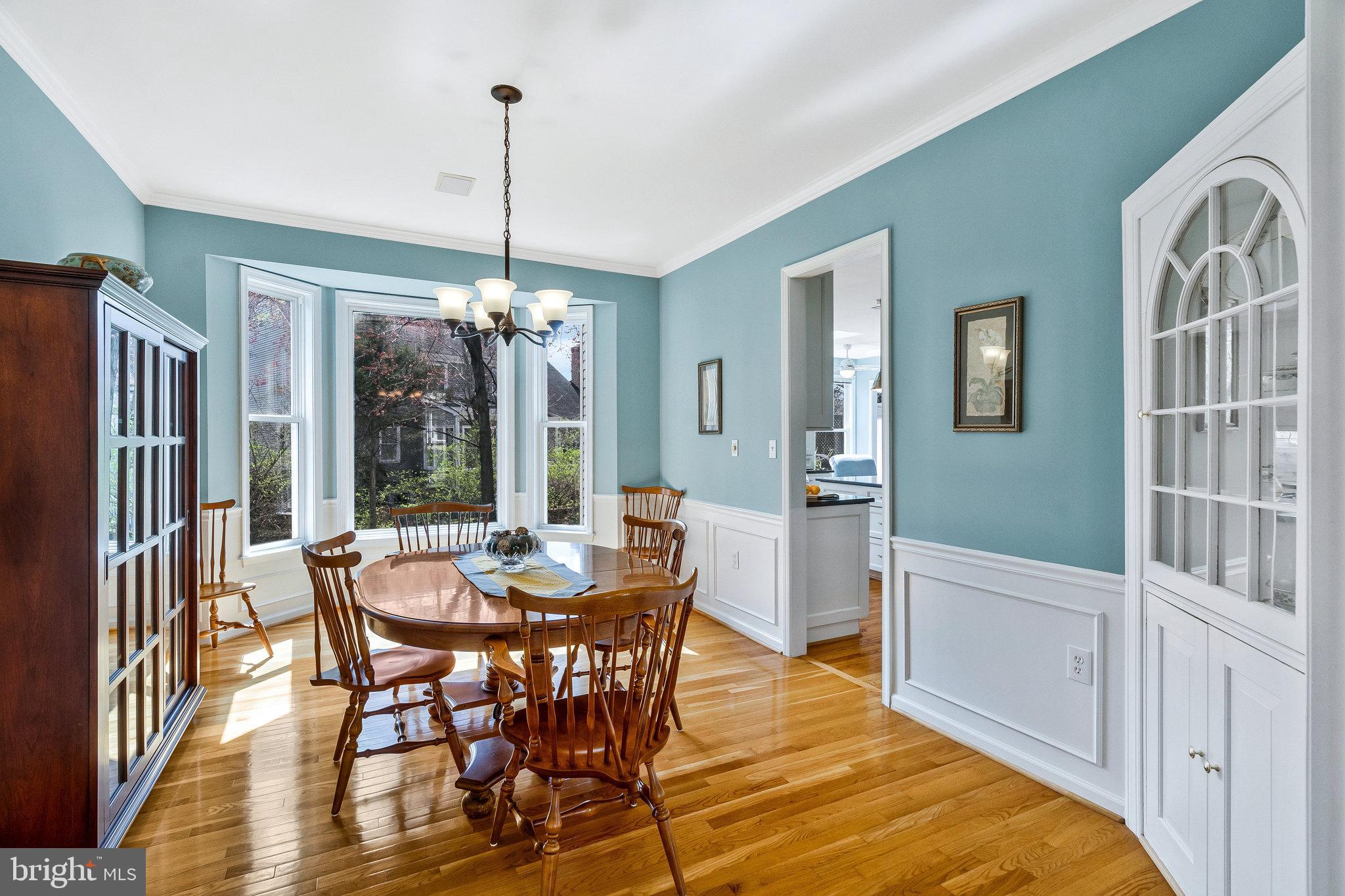 46865 Backwater Drive Sterling, VA 20164 - Photo 16 of 53 a dining room with furniture a chandelier and wooden floor