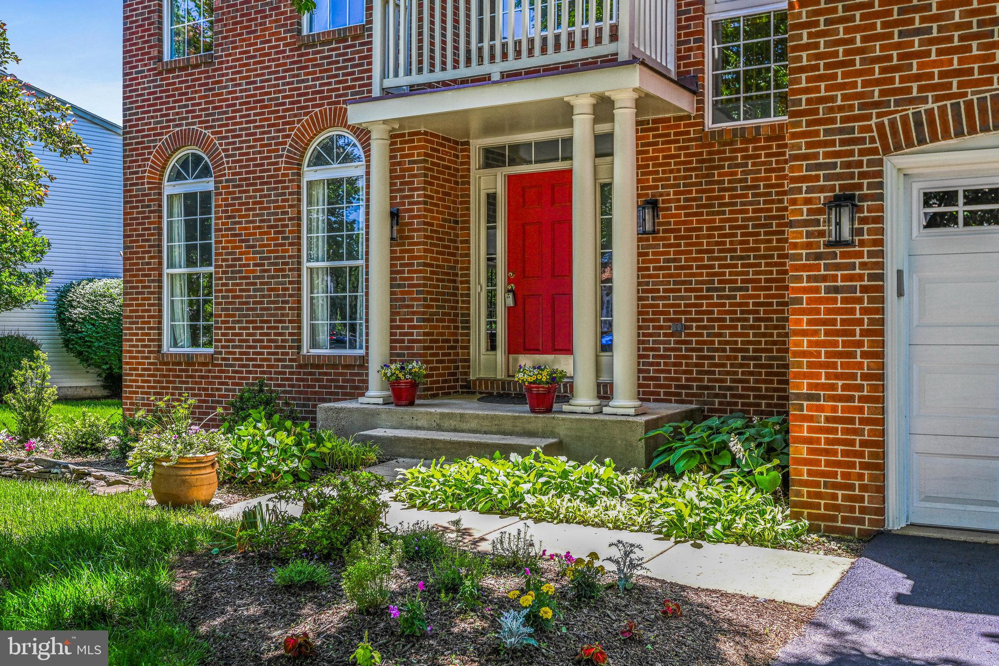 46865 Backwater Drive Sterling, VA 20164 - Photo 2 of 53 a front view of a house with a yard and flowers
