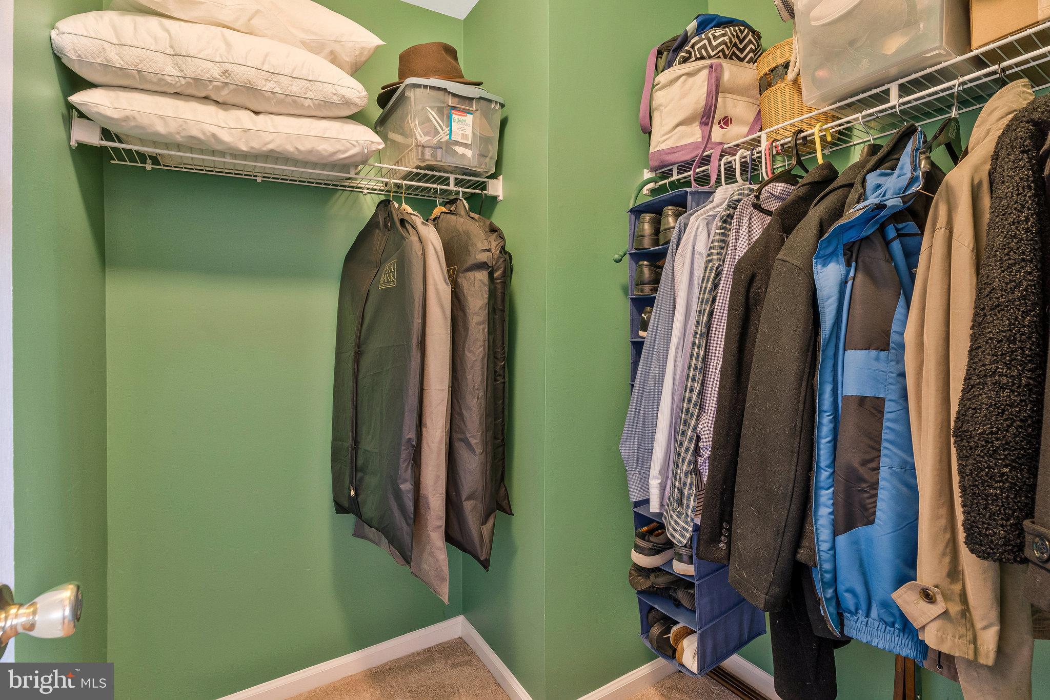 46865 Backwater Drive Sterling, VA 20164 - Photo 37 of 53 a view of walk in closet with clothes and shoes