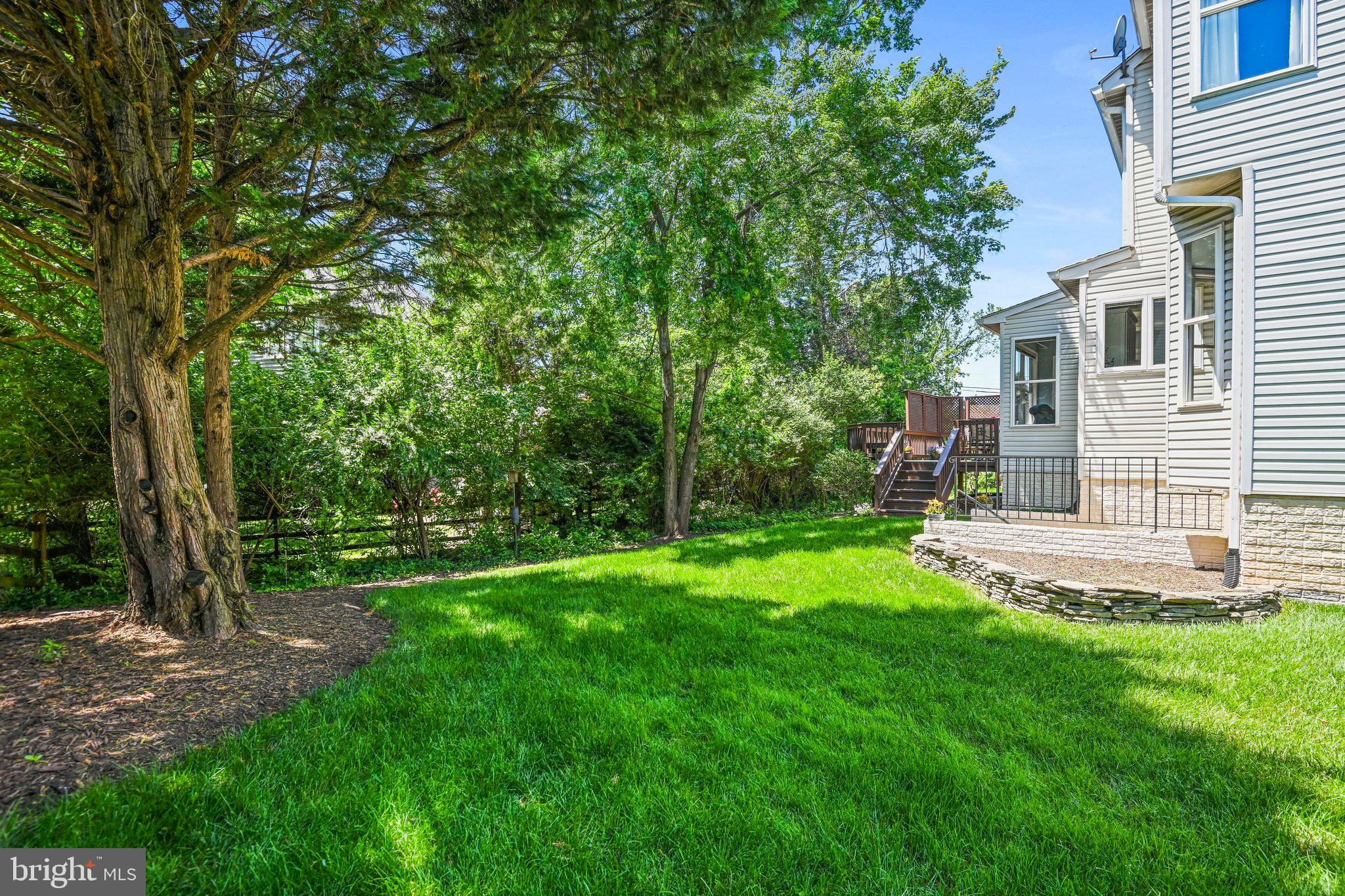 46865 Backwater Drive Sterling, VA 20164 - Photo 46 of 53 a view of a backyard with table and chairs and large trees