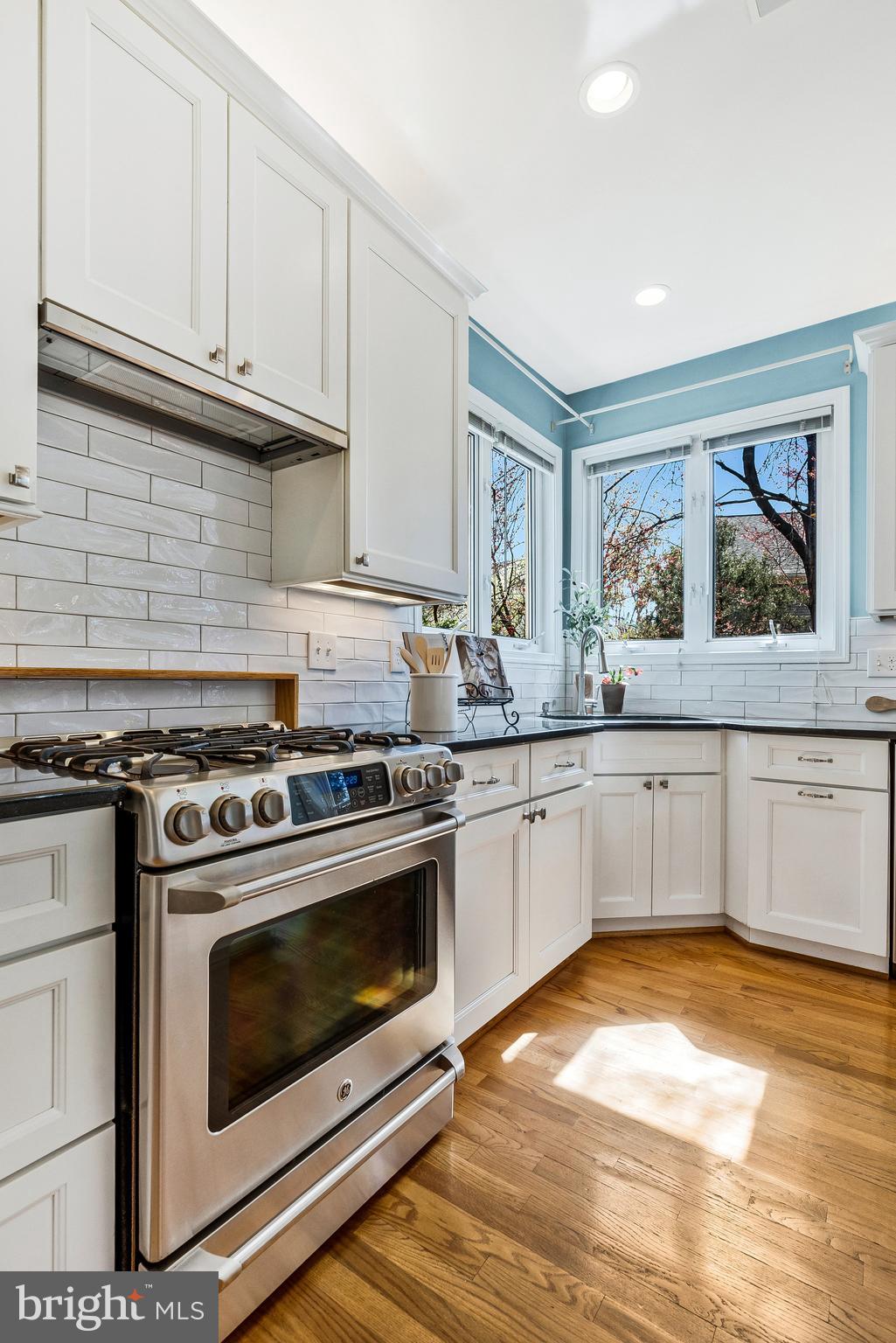 46865 Backwater Drive Sterling, VA 20164 - Photo 9 of 53 a kitchen with granite countertop a stove and a sink