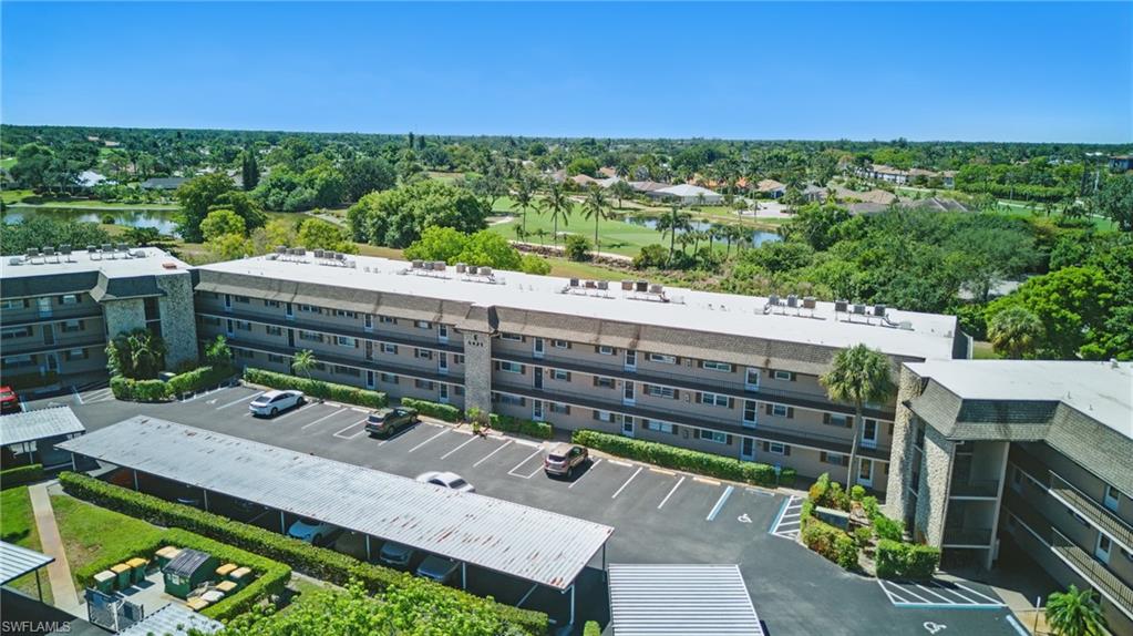 5435 Rattlesnake Hammock Road, Unit E202 Naples, FL 34113 - Photo 1 of 25 a view of a patio with wooden floor