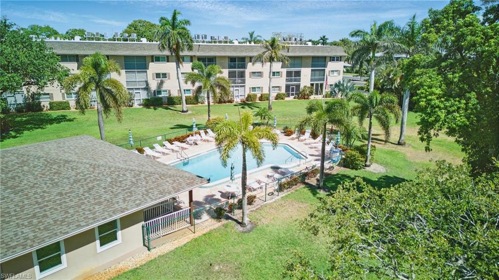 5435 Rattlesnake Hammock Road, Unit E202 Naples, FL 34113 - Photo 21 of 25 an aerial view of a house with a yard table and chairs