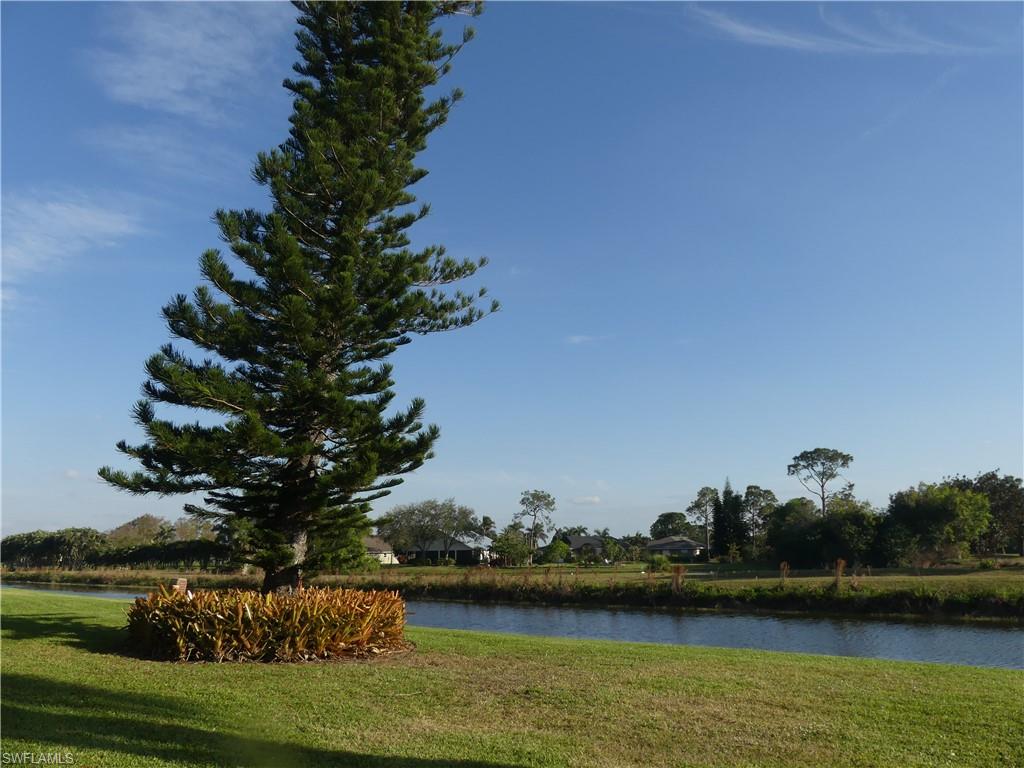 5435 Rattlesnake Hammock Road, Unit E202 Naples, FL 34113 - Photo 22 of 25 a view of a lake with houses in outdoor space
