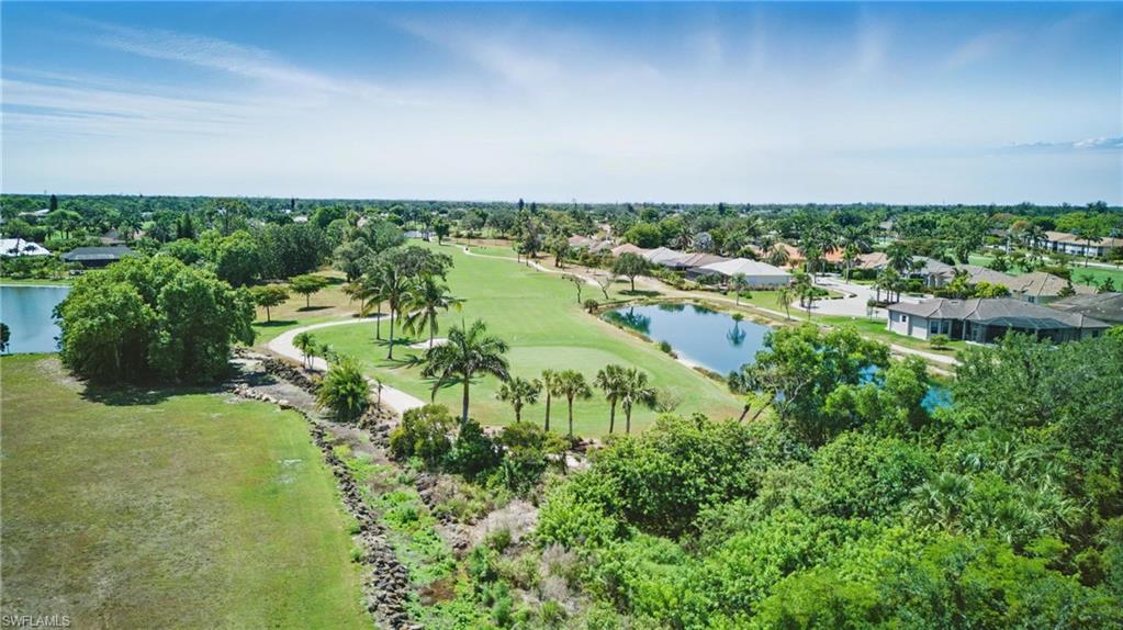 5435 Rattlesnake Hammock Road, Unit E202 Naples, FL 34113 - Photo 24 of 25 a view of a lake with houses in back