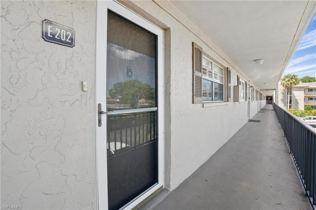5435 Rattlesnake Hammock Road, Unit E202 Naples, FL 34113 - Photo 4 of 25 a view of a hallway with windows