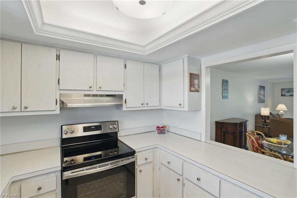 5435 Rattlesnake Hammock Road, Unit E202 Naples, FL 34113 - Photo 7 of 25 a kitchen with cabinets appliances and a counter space