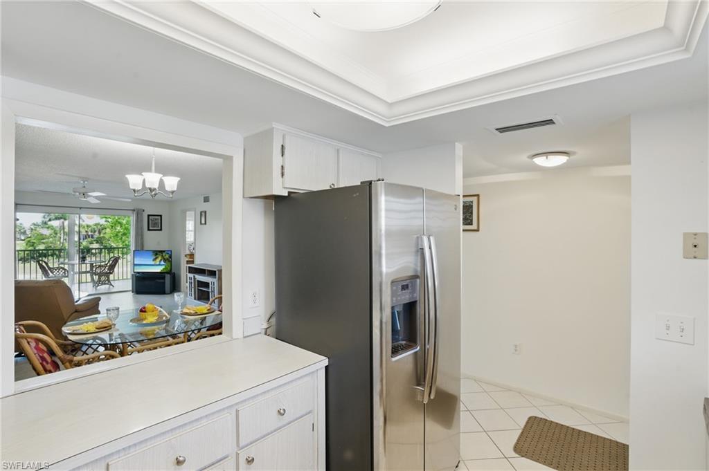 5435 Rattlesnake Hammock Road, Unit E202 Naples, FL 34113 - Photo 8 of 25 a kitchen with a refrigerator and a sink