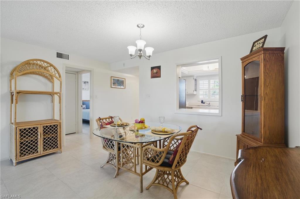 5435 Rattlesnake Hammock Road, Unit E202 Naples, FL 34113 - Photo 9 of 25 a dining room with furniture and window