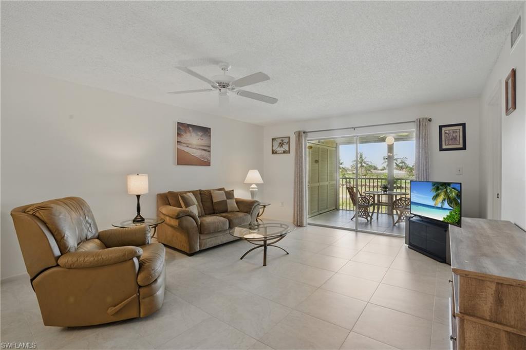 5435 Rattlesnake Hammock Road, Unit E202 Naples, FL 34113 - Photo 10 of 25 a living room with furniture and a window