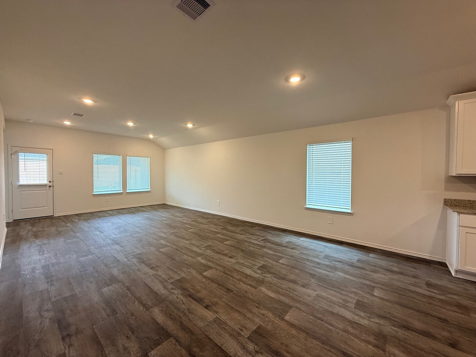 3807 Axyl Run Fulshear, TX 77423 - Photo 11 of 29 an empty room with wooden floor and windows